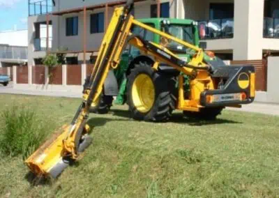 reach mower attachment connected and mowing the grass