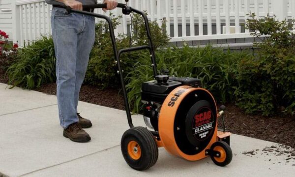 Scag Giant-Vac Classic Blower clearing bark off walkway out front of a house