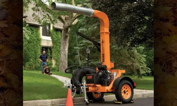 Scag Giant-Vac Tow Behind Truck Loader front of a house